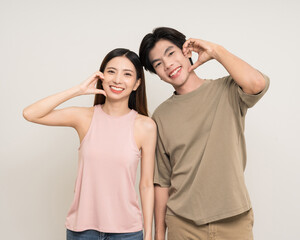 Happy asian couple attractive in various action gesture standing on isolated white background. Cheerful Smiling young man and woman showing heart sign mini heart