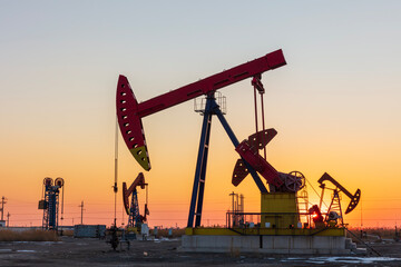 In the evening, oil pumps are running, Silhouette of beam pumping unit