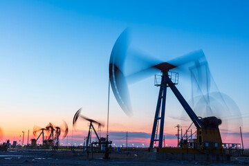 In the evening, oil pumps are running, Silhouette of beam pumping unit