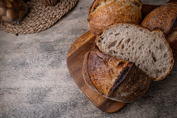 Golden-Crusted Artisan Sourdough Bread on a Rustic Wooden Table.