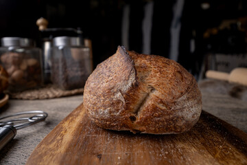 Golden-Crusted Artisan Sourdough Bread on a Rustic Wooden Table.