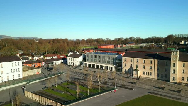 Aerial shot of Ebrington Square in Derry-Londonderry, NI on a bright and sunny day. The camera travels backwards, revealing the square. Filmed in 4K at 60fps and in Rec709 color space.