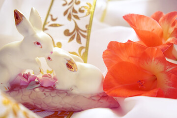 Easter bunny, beautiful home decoratoins. Spring fresh flowers and pastel colors background.Morning sunlight. Easter Card. Happy Easter