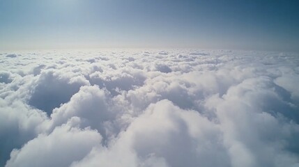 Fototapeta premium Aerial view of fluffy white clouds against a clear blue sky
