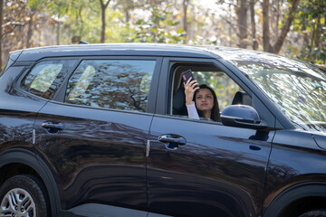 young woman driving in car and checking her phone network, annoyed by navigation gps system or bad text message or email,
