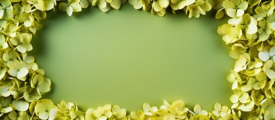 Golden square frame with dried hydrangea flowers on a green background vertical flat lay composition ample copy space serene botanical decor