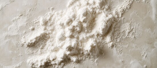 Minimalist composition of textured beige background with a delicate white cloud of puffed flour positioned centrally, emphasizing natural baking essentials.