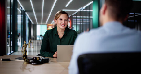 Female Lawyer And Her Client Discussing Divorce Proceedings
