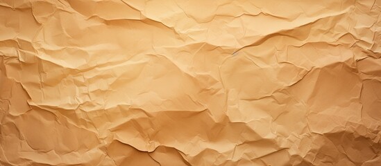 Obraz premium Torn brown paper background with deep wrinkles and texture in warm beige tones, creating a natural and vintage look for design projects.