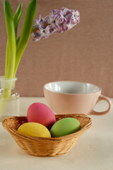 colorful easter eggs with a purple hyacinth and teacup.