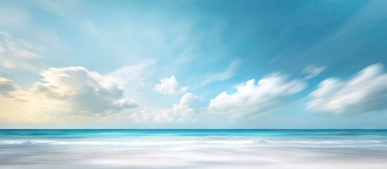 Vibrant summer landscape with a blurred horizon, clear blue sky, and fluffy white clouds, creating a serene ocean view in soft pastel colors