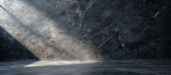 Elegant dark gray marble wall texture with light beams streaming from the left creating a sophisticated and dramatic design backdrop for decor.