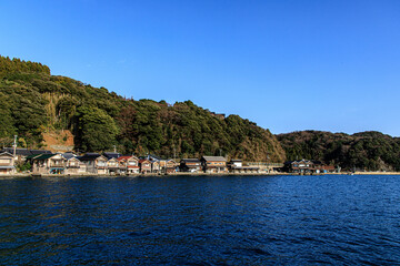 Fototapeta premium Traditional Wooden Boat Houses Lining the Waterfront in Ine, Kyoto, Japan