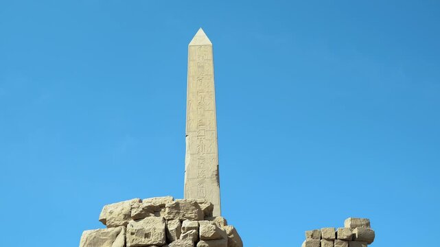 View of a tall obelisk in the ancient city of Karnak