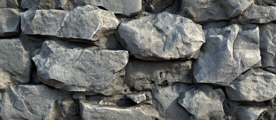 Matte grey stone concrete texture with rough uneven surfaces arranged in horizontal layers creating a solid, sophisticated background for design projects