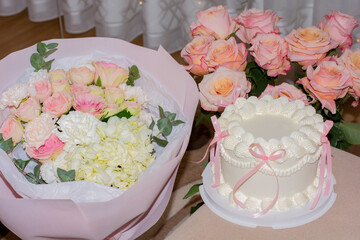 Cake and delicate bouquets of flowers in the house, congratulations, holiday, Valentine's Day. High quality photo