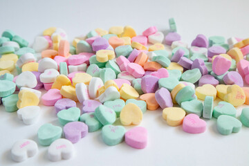 Conversation colorful candy hearts scattered at eye level.