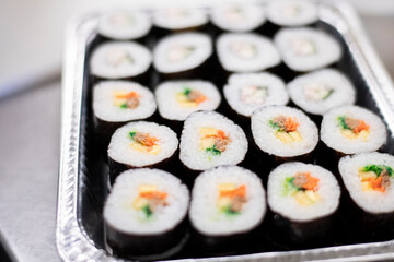 Okazuya maki sushi platter in service dish in Japanese deli