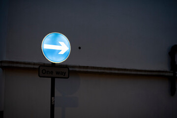 Lighted one way sign at dusk in Notting Hill London UK England
