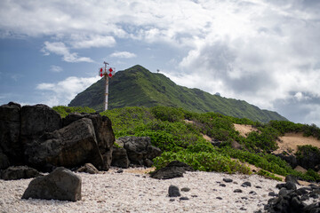 Naklejka premium View of lush green mountain with satellite dish on Ka'Ena Point