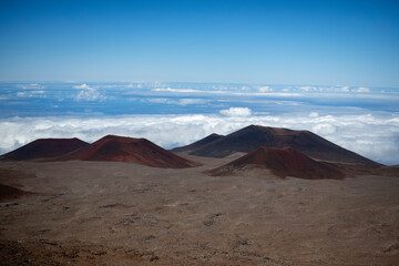 Red volcanic landscape above clouds on Mauna Kea Hawaii