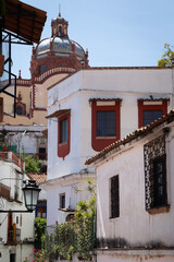 Fototapeta premium Colonial buildings, including church dome, in central Mexico