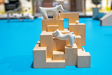 cute white abstract figurine of a dog or cat on a wooden design ladder