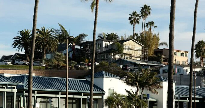 Beautiful palm trees and buildings on a warm afternoon in downtown Encinitas, California, USA.
