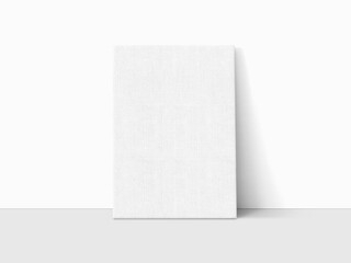 A white canvas leaning against the white wall mockup