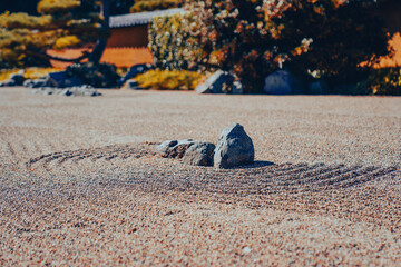 Zen Rock Garden with Raked Gravel and Natural Greenery in a Tranquil Setting