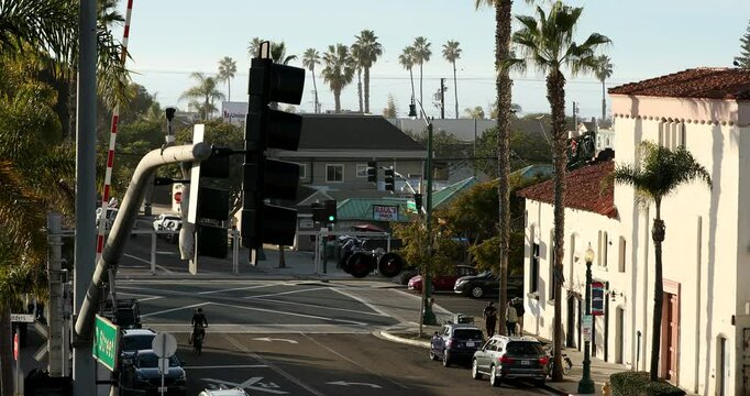 Encinitas, California, USA - September 3, 2022: Bustling traffic passes through the historic downtown district buildings of Encinitas.