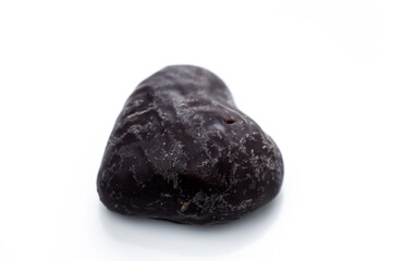 Unique heart-shaped stone with textured surface resting on a bright background
