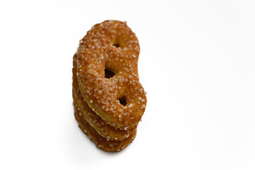 Crispy golden snack shaped like a kidney bean with textured salt crystals on a white background