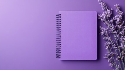Purple notebook placed next to lavender flowers on a vibrant purple background creating a calming aesthetic