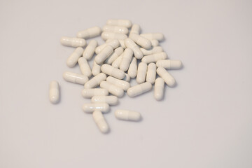 Medical pills in white, and other colors. Concept of healthcare and medicine.