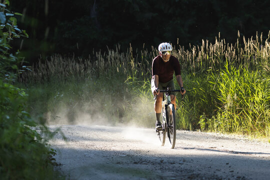 Cycling through a forest road, blending endurance, and adventure