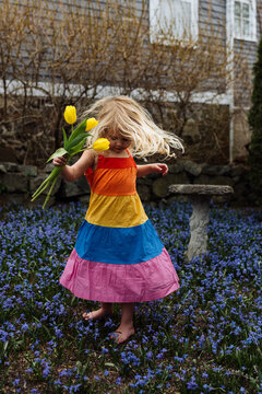 Young girl twirling in the flowers