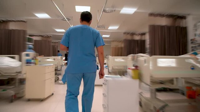 Rear view of doctor entering intensive care unit 
