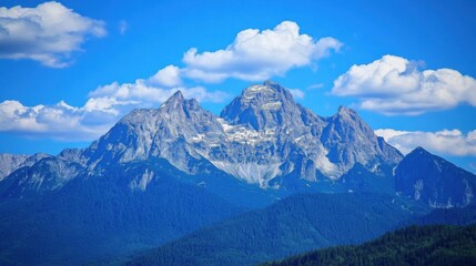 Fototapeta premium Majestic mountains rise against a crystalclear blue sky.