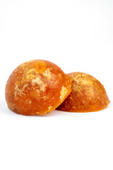 Juicy and rich natural jaggery blocks displayed on a white backdrop showcasing their texture and color.