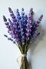 Naklejka premium A bundle of branches adorned with dried lavender purple blue flowers, blue, flower bouquet, rustic
