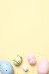 Colorful eggs, sweet confetti on pastel color backdrop, space for your text or advertisement