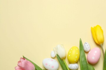 Colorful eggs with tulip flowers on pastel color backdrop, space for your text or advertisement