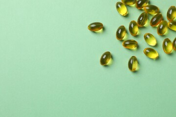 Capsule of omega 3, 6, 9 fish oil, vitamin, food supplement on color background