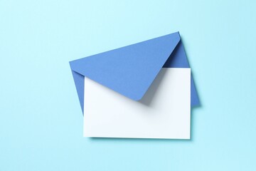 White paper card with blue envelope on color background