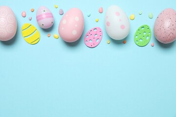 Colorful eggs, sweet confetti on pastel color backdrop, space for your text or advertisement