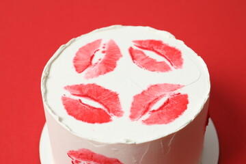 Colorful cake decorated with red lips on colorful background