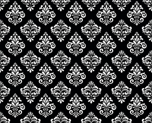 Wallpaper in the style of Baroque. Seamless vector background. White and black floral ornament. Graphic pattern for fabric, wallpaper, packaging. Ornate Damask flower ornament.
