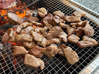 beef and pork being grilled on the barbeque 