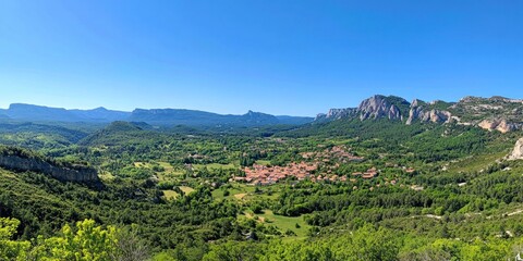 Obraz premium Panoramic View of a Picturesque Village Nestled in a Mountain Valley
